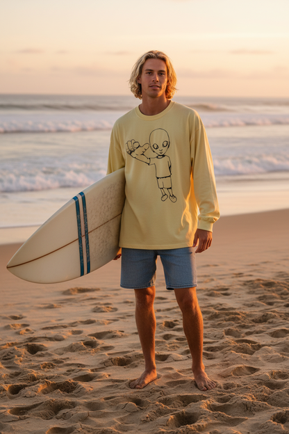 Blonde surfer wearing yellow xTra heavyweight long sleeve tee at the beach